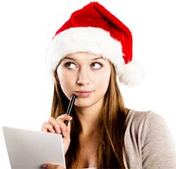 Woman in a Santa hat thinking and writing a list