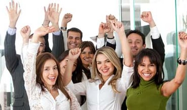 Employees raising their arms and smiling.